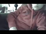 A slender boy in a sweatshirt masturbates in his living room