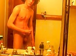 Curly-haired twink in bathroom